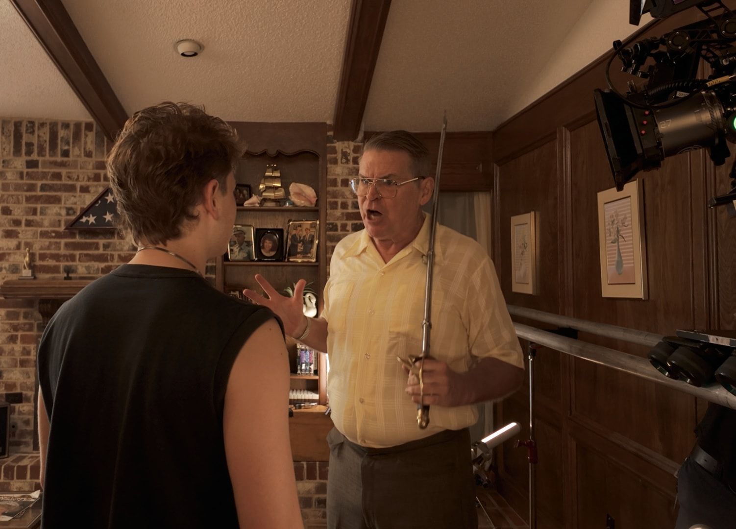 Bill Wise holding a sword on the living room set