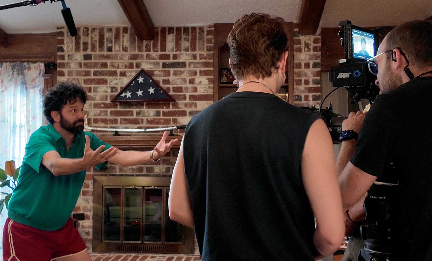 Brian Villalobos rehearsing by the fireplace while the camera rolls