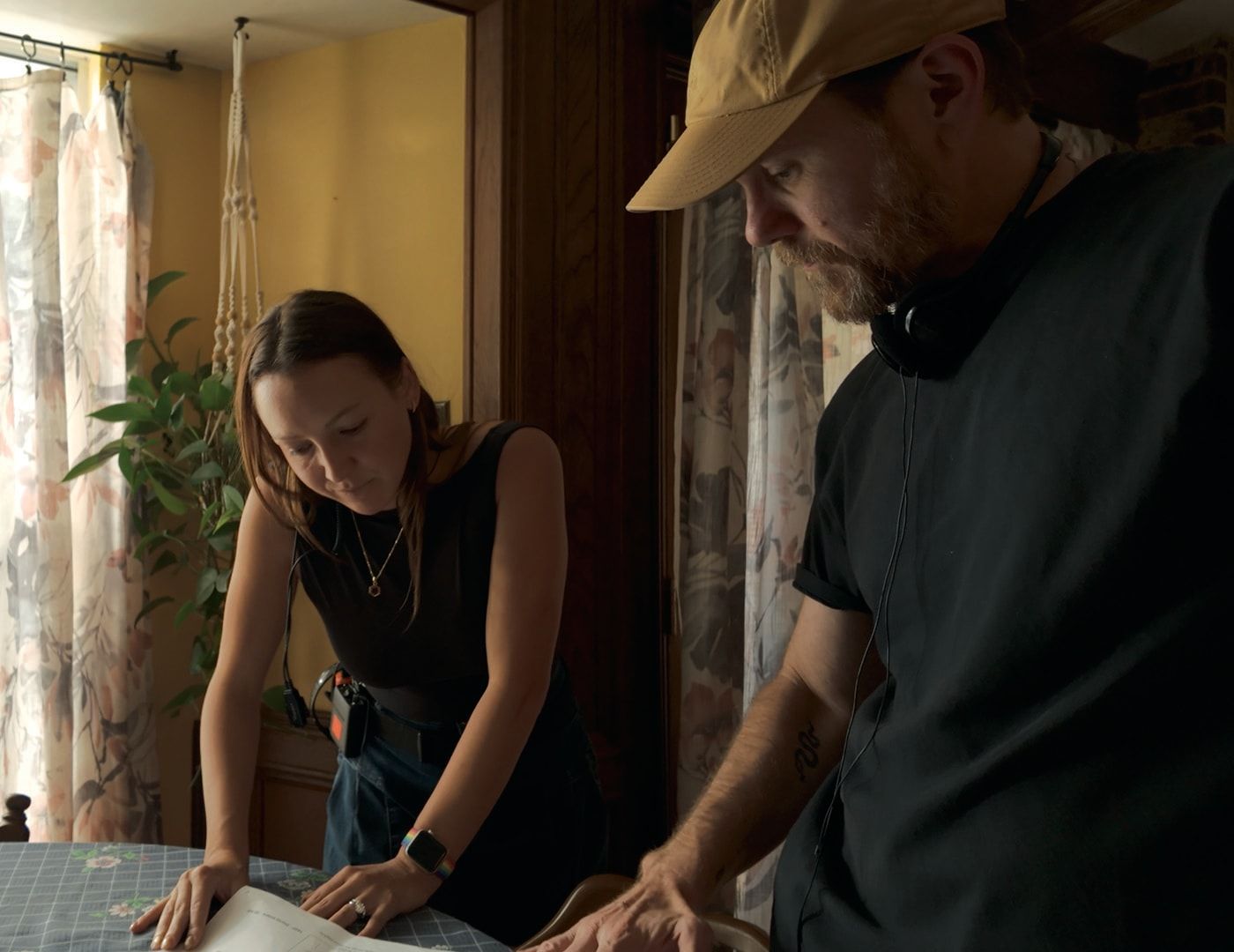 Two crew members going over the script at the kitchen table