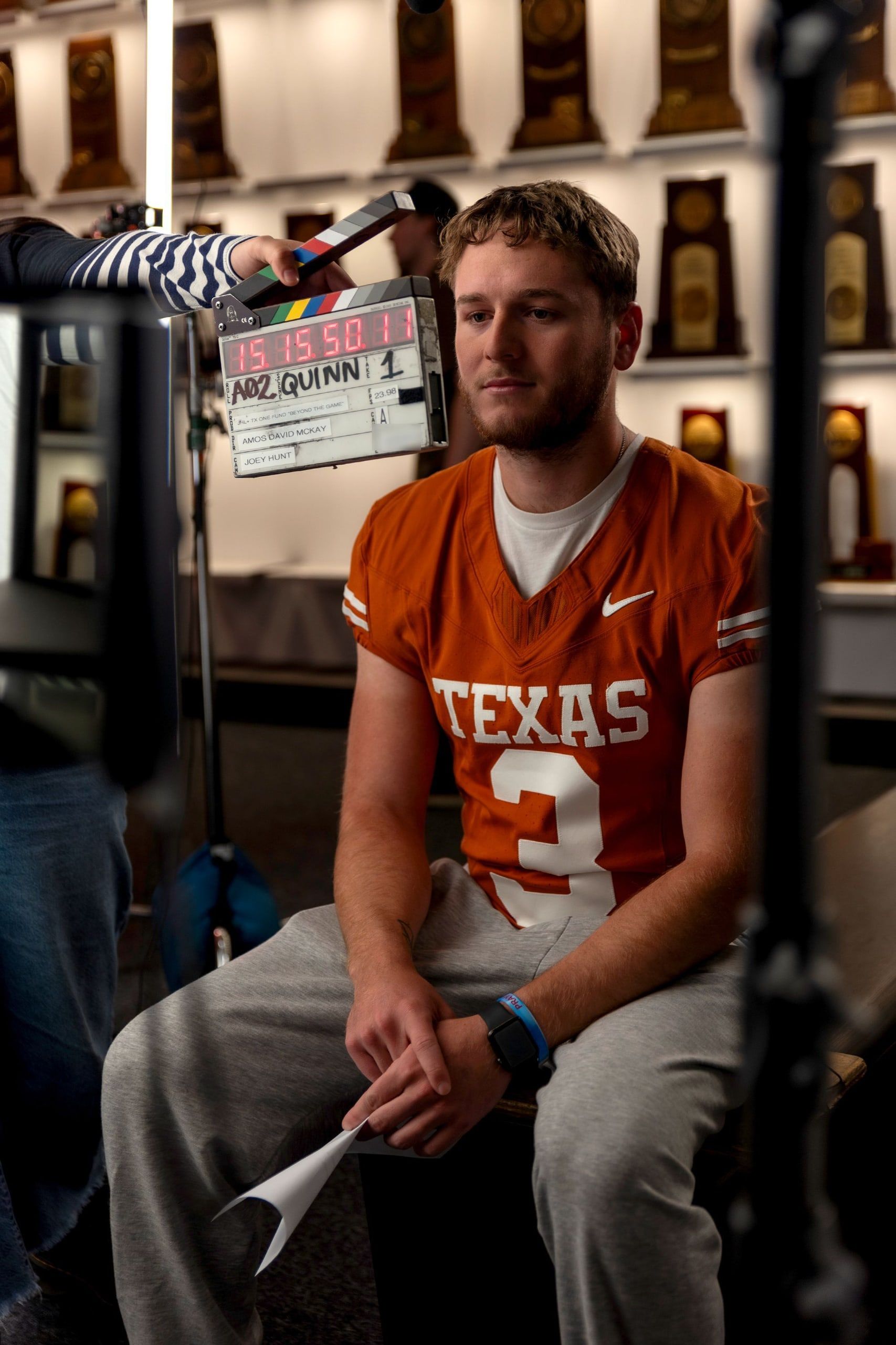A slate in front of a Texas football player in a number 3 jersey before his interview